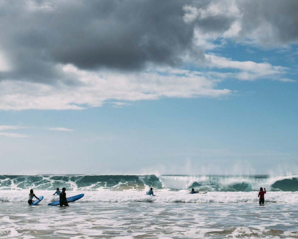 Young men surfing in sea